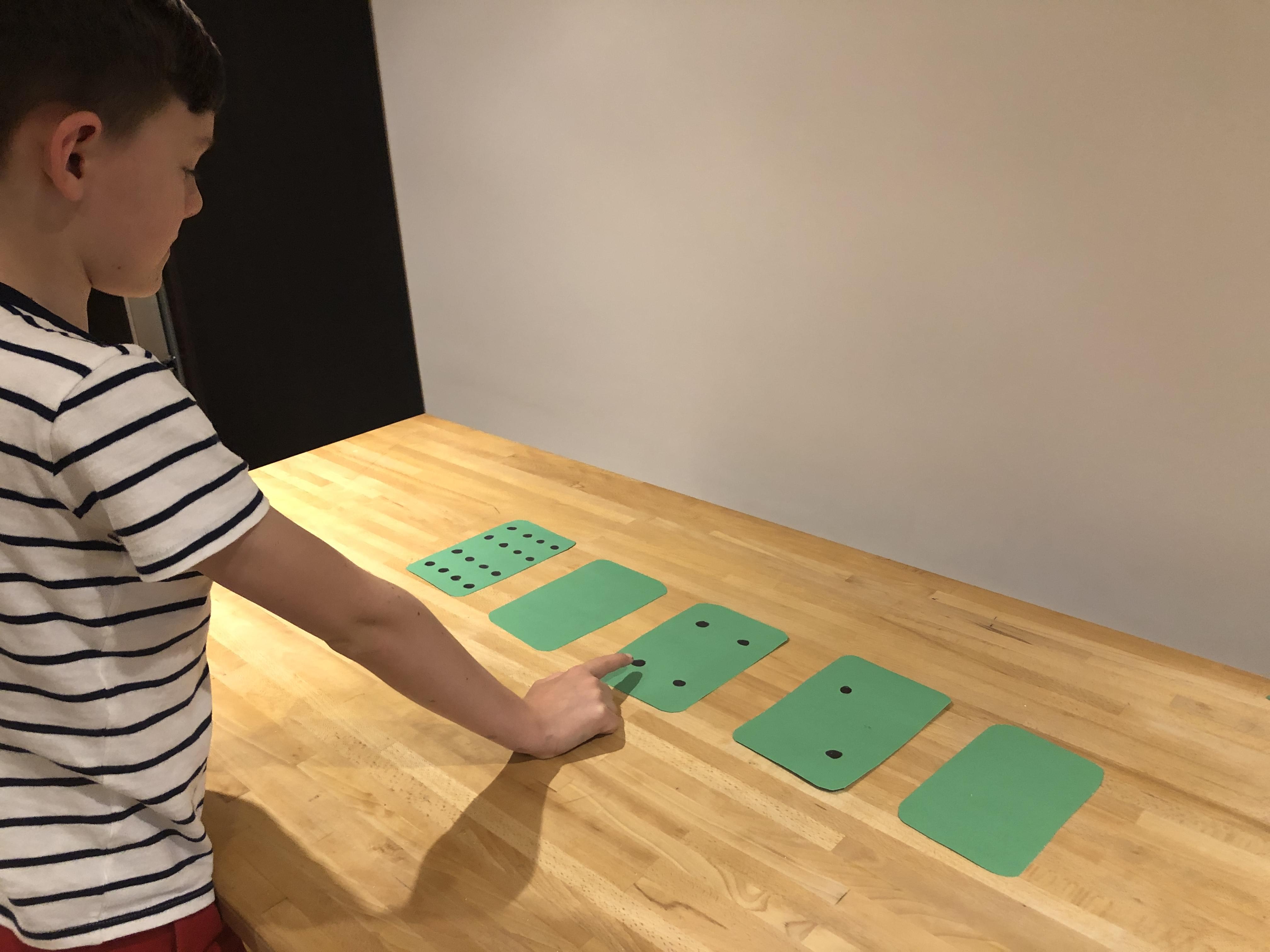 Child counting up the number of dots.