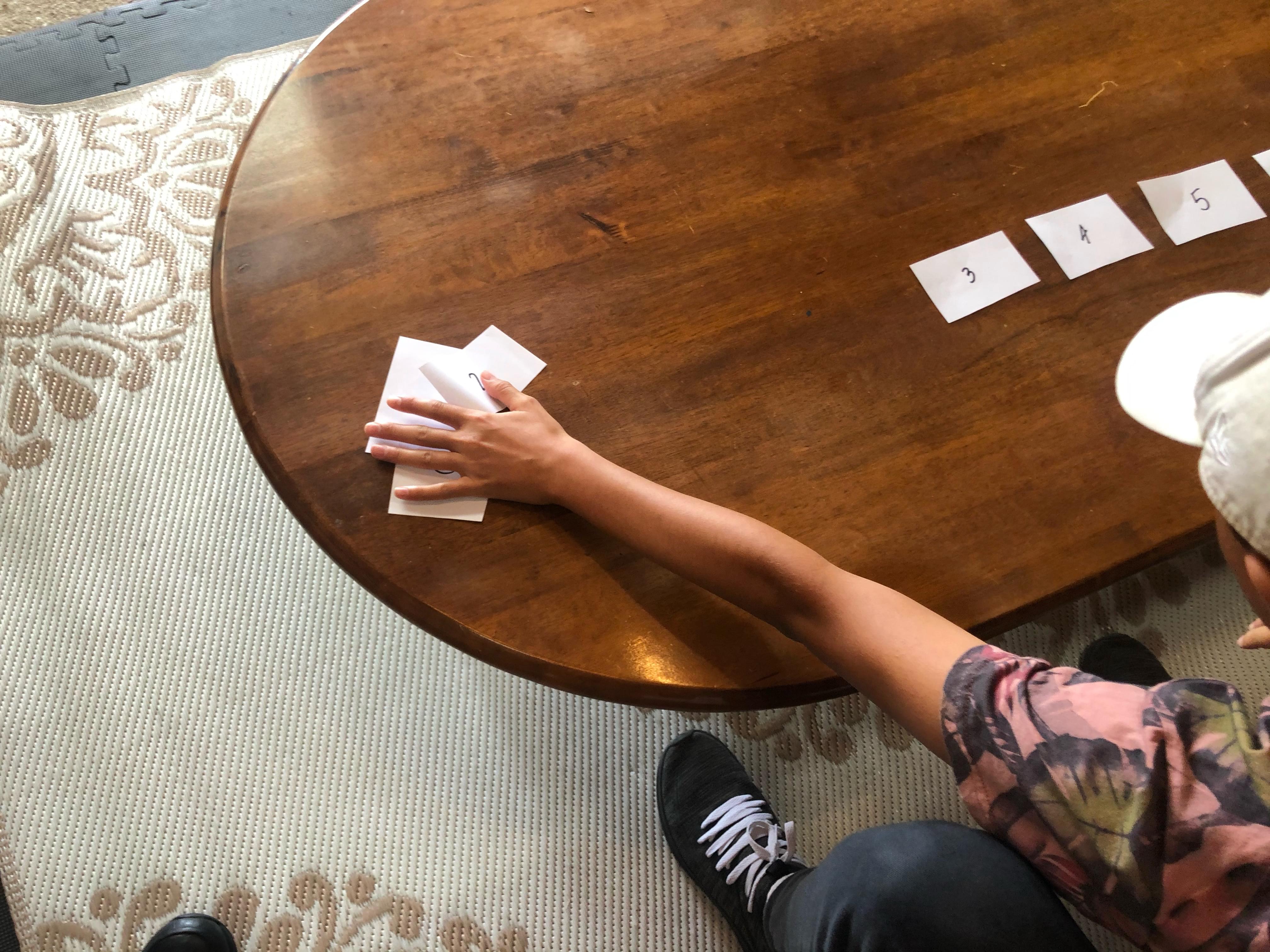 Child moving all smaller cards to one side.